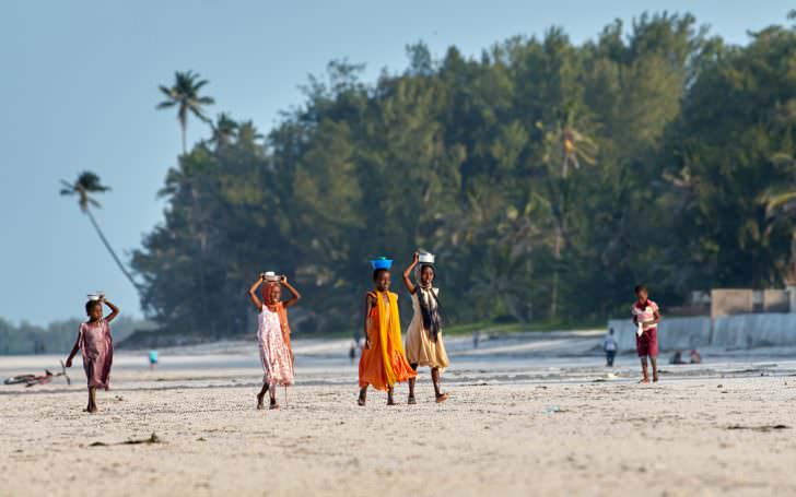 Local children walking on the beach in Jambiani, Zanzibar