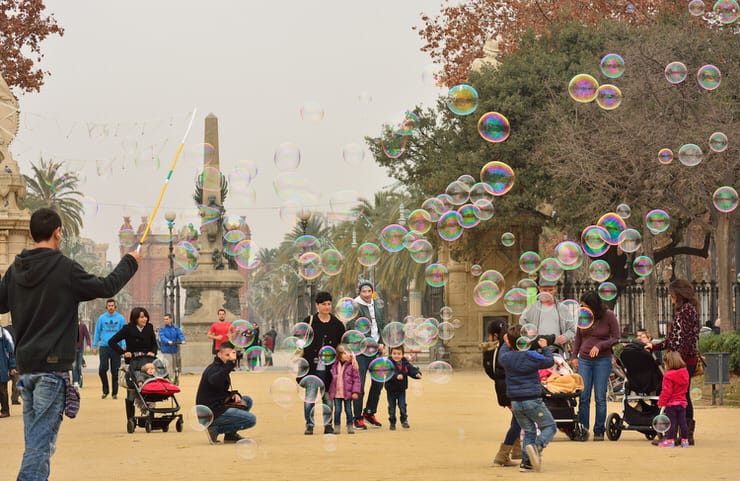 Children enjoy soap bubbles within Ciudadela Park, Barcelona