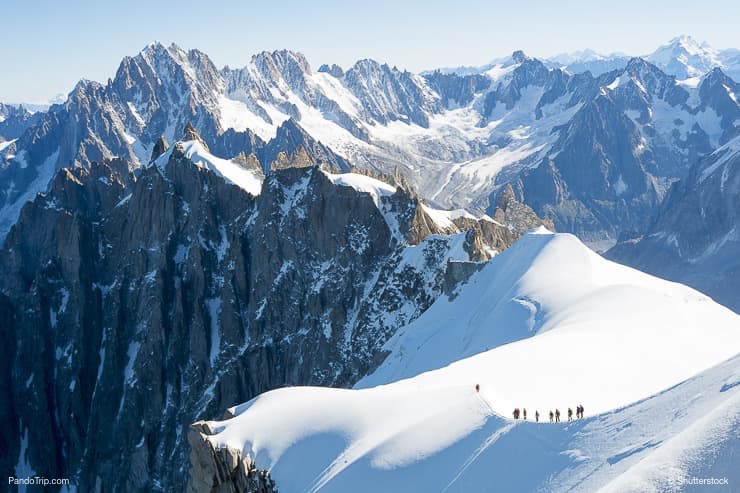 Mont Blanc mountaneers walking on snowy ridge