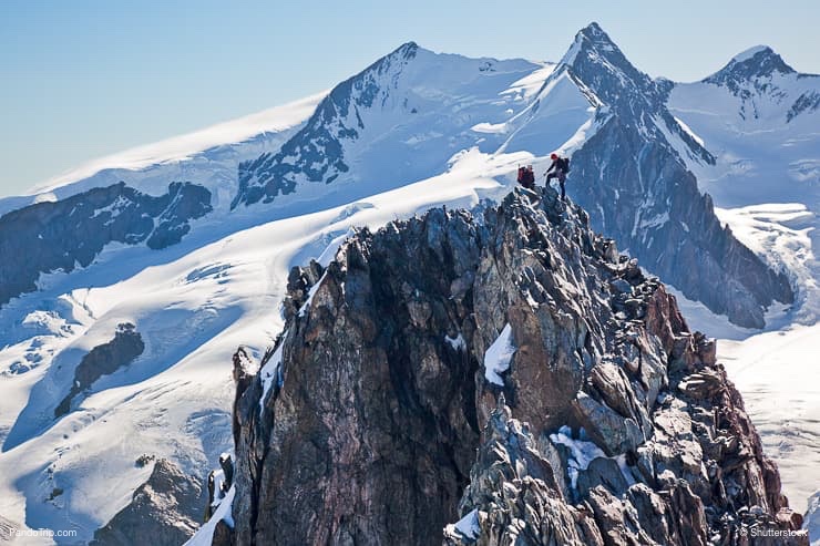 Two mountaineers climb the ridge of Breithorn in Monte Rosa massif