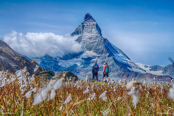 Hiking in the Switzerland alps with Matterhorn peak in the background