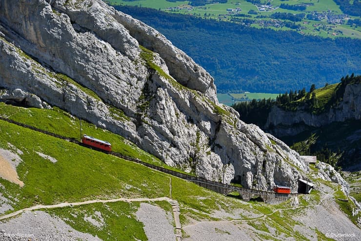 The two red Pilatus train, the world's steepest cogwheel railway nears the top of Mount Pilatus