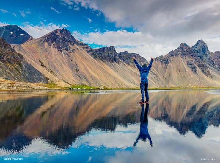 Amazing reflection. Photographer taking photo of famous Vestrahorn Mountain