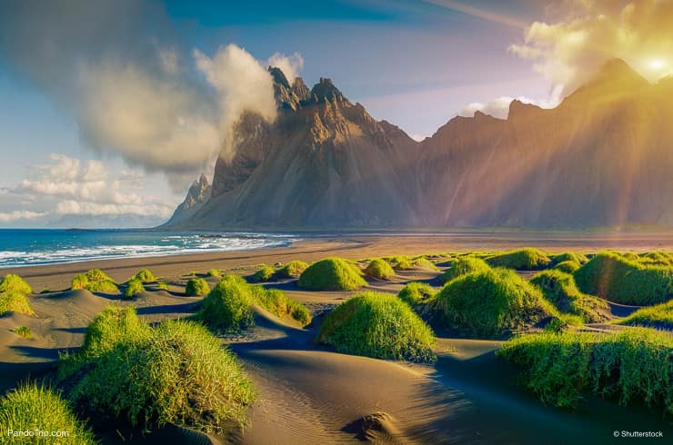 View of green dunes on the Stokksnes headland with Vestrahorn mountain on background