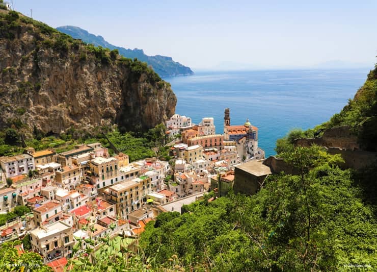 Aerial view of Atrani village between green branches and cliff rocks, Amalfi Coast, Italy