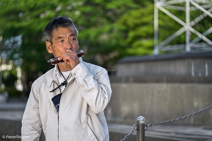 Japanese Man playing harmonica at Sumida Park