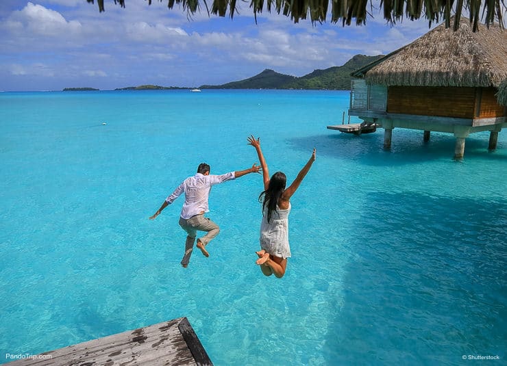 Jumping in the water in Bora Bora, French Polynesia, Pacific Ocean