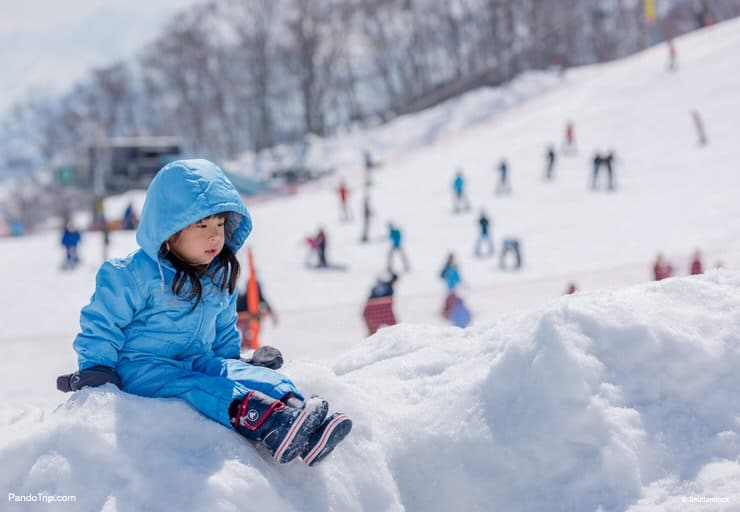 Girl playing with snow at Gala Yuzawa in Japan
