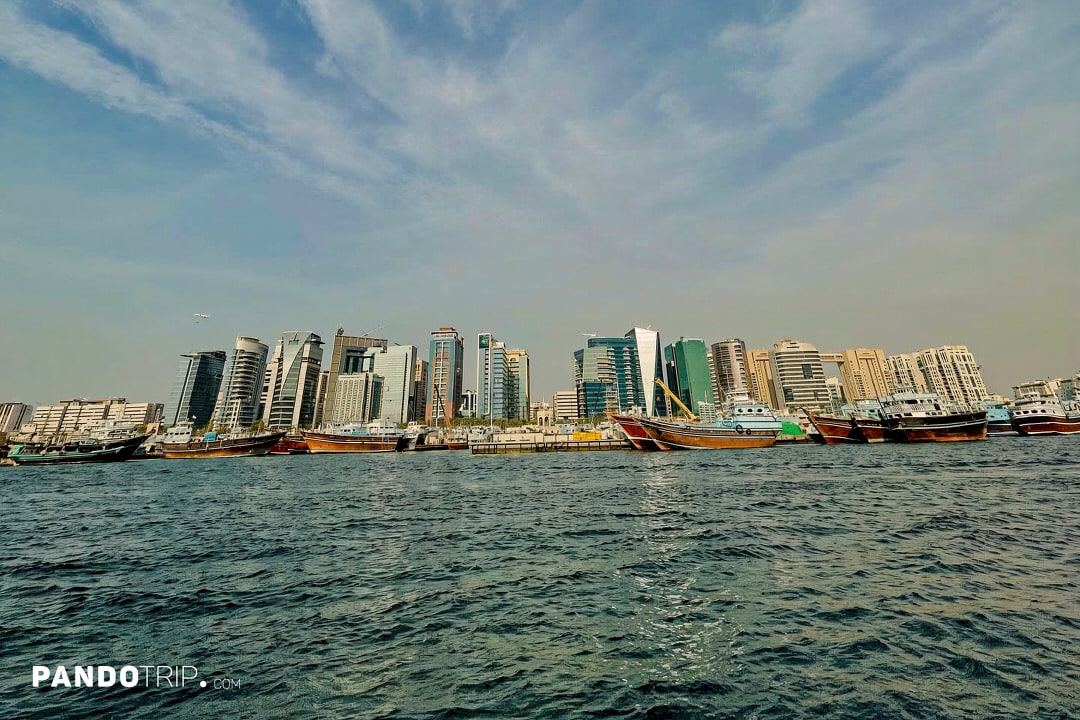 Dubai Creek with traditional dhow boats docked along the waterfront