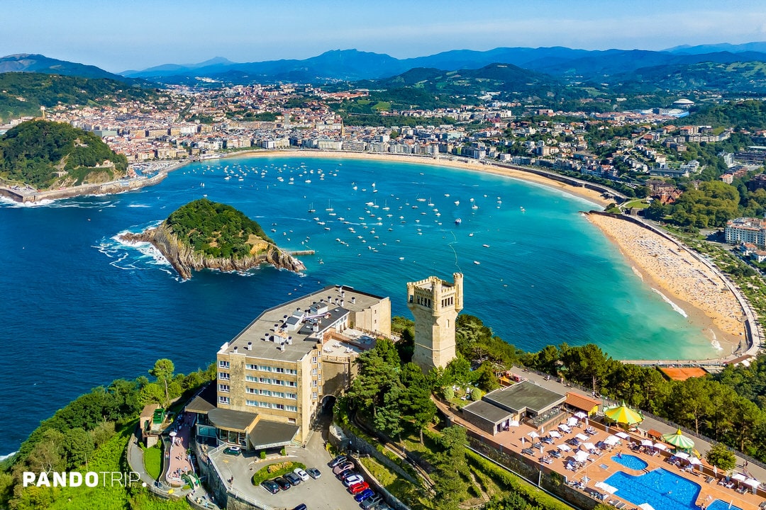 Panoramic aerial view of La Concha Bay, Isla Santa Clara, and the cityscape of San Sebastián, Spain