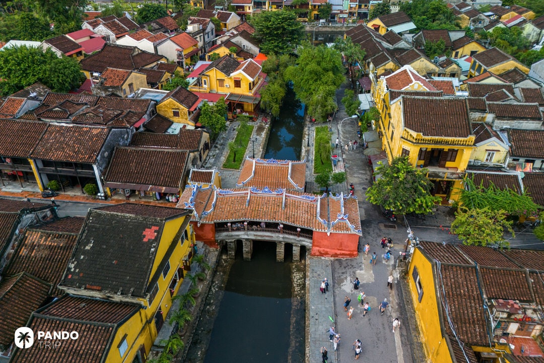 Aerial view of the historic Japanese Covered Bridge in Hoi An, surrounded by yellow heritage buildings