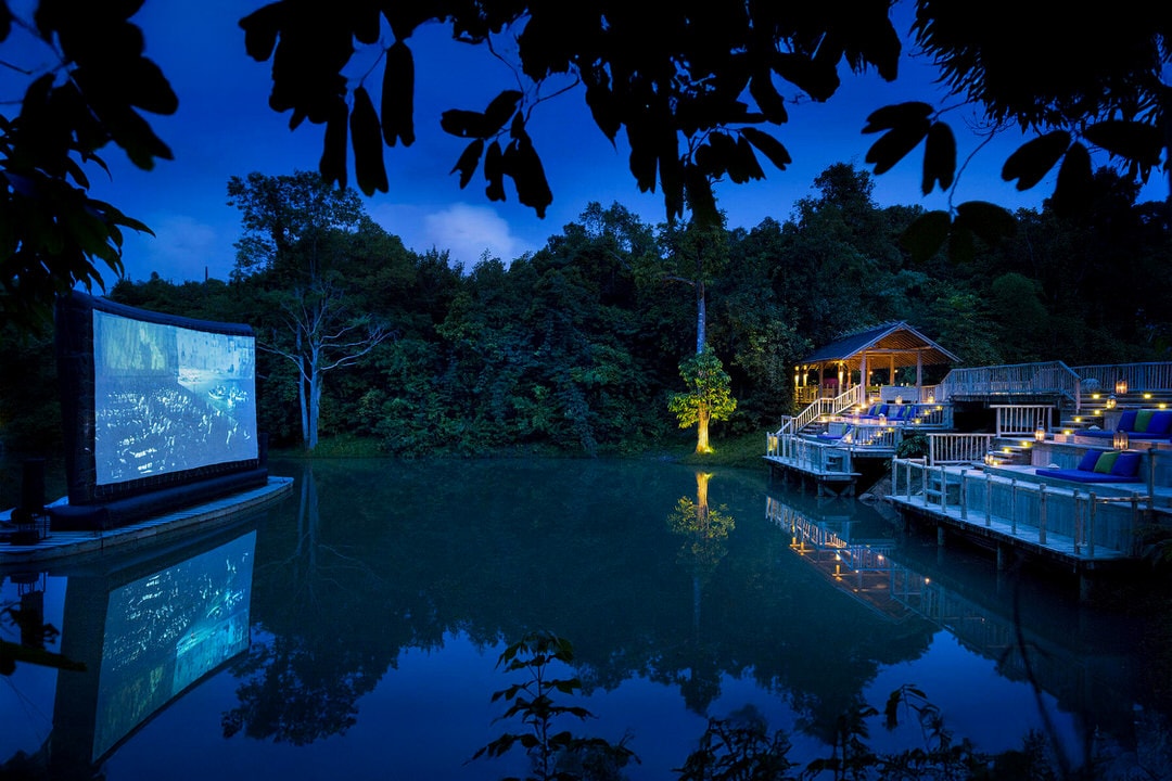 Lagoon movie theater at Soneva Kiri’s Cinema Paradiso on Koh Kood island, outdoor screen reflected on the water surrounded by jungle
