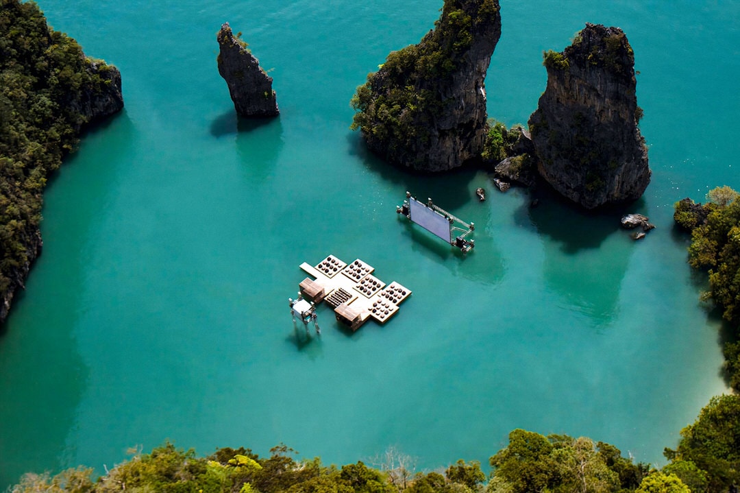 Floating cinema rafts and screen on turquoise water in Thailand’s Phang Nga Bay during the 2012 Archipelago Cinema