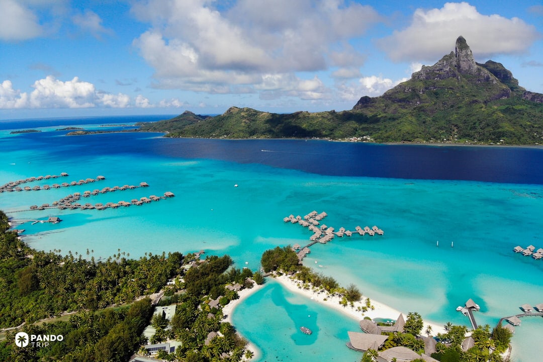 Aerial view of Bora Bora lagoon with overwater bungalows and Mount Otemanu in French Polynesia