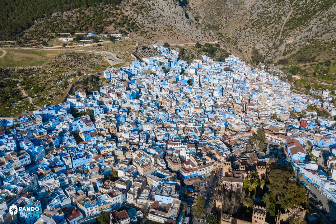Aerial view of Chefchaouen showing blue-painted houses set against the Rif Mountains