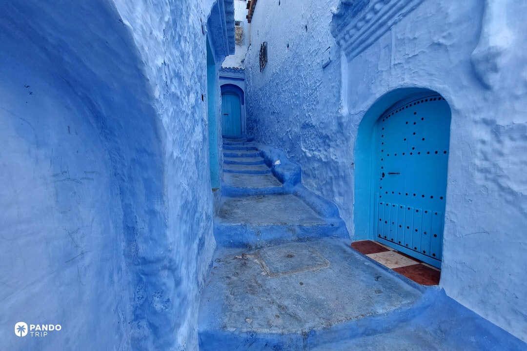 Narrow staircase alley painted in blue in Chefchaouen, Morocco