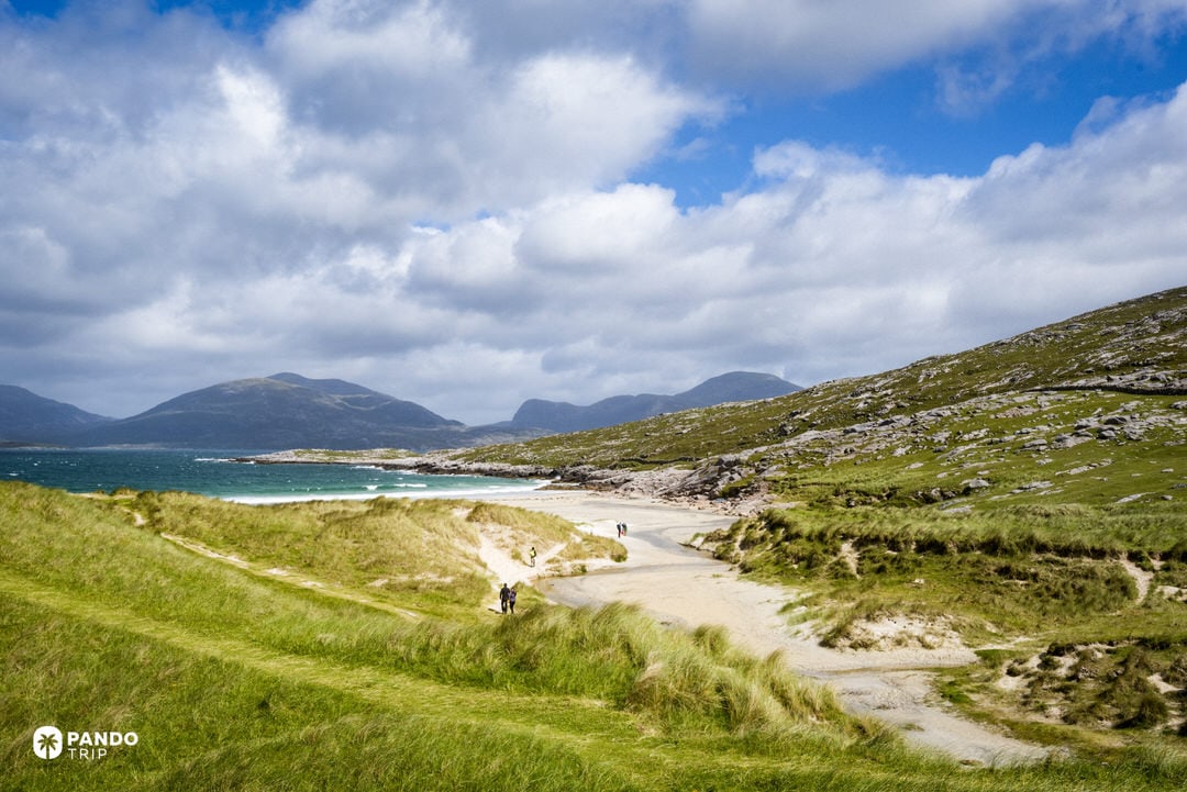 Sandy path through high marram dunes leading toward Luskentyre bay.