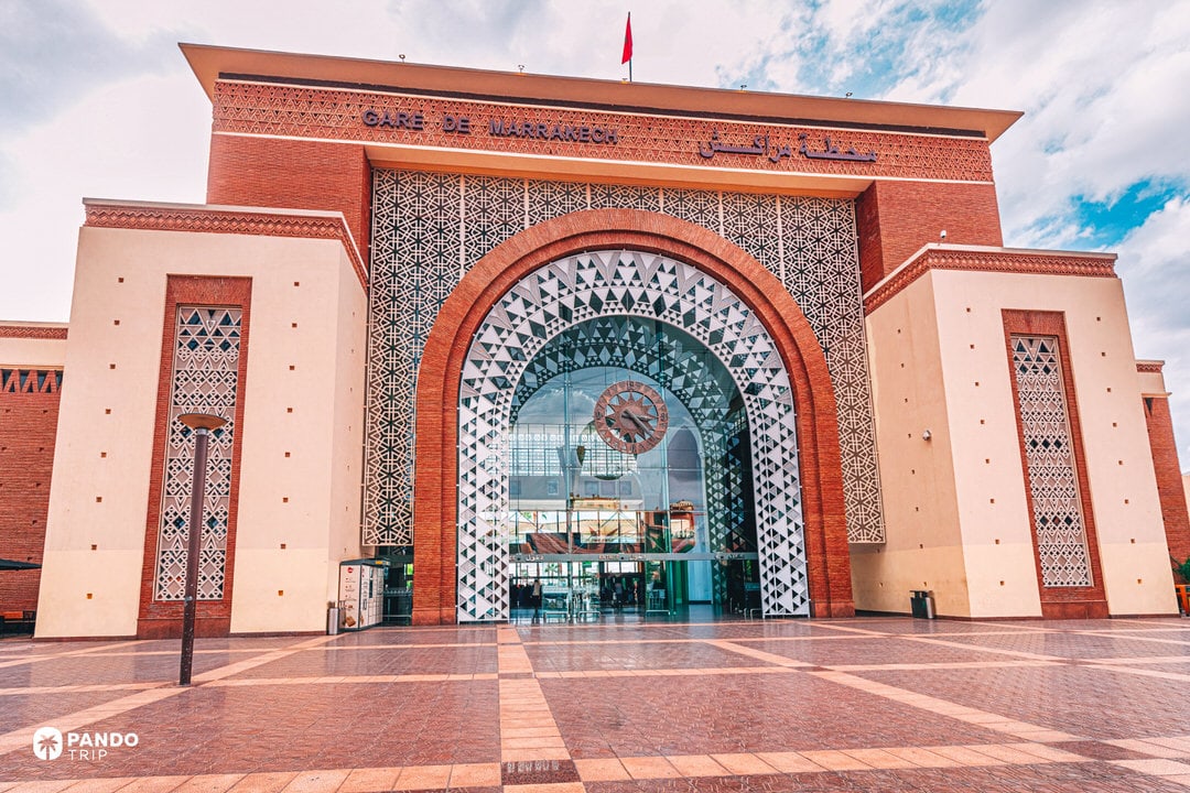 Entrance of Marrakech railway station with decorative Moroccan architecture, starting point for long trips to Chefchaouen