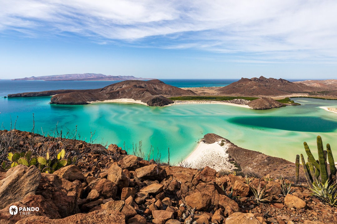 Puerto Balandra beach with shallow turquoise waters and desert cliffs in Mexico