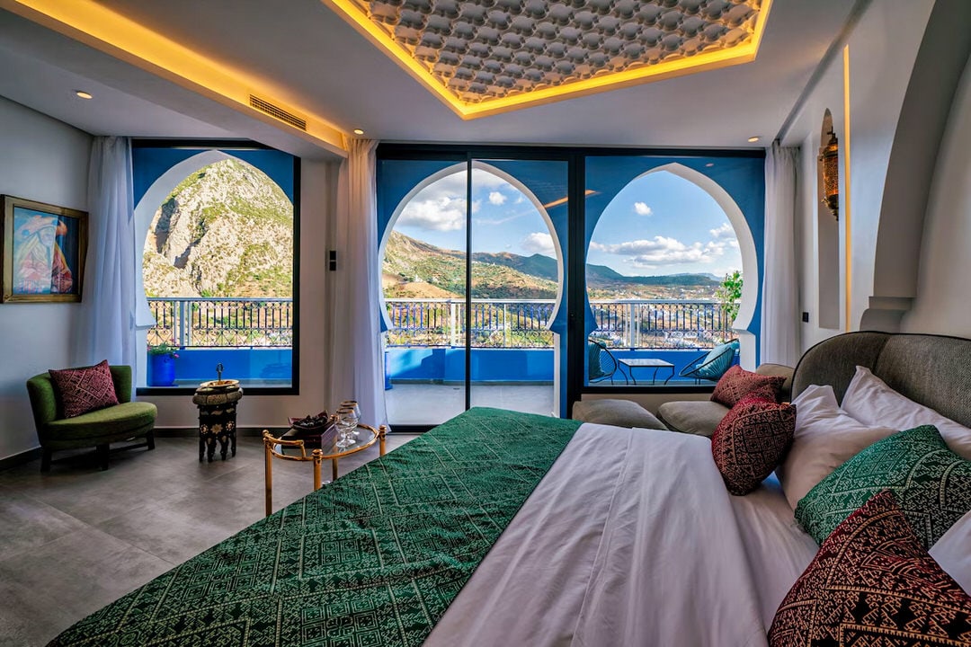 Luxury hotel suite at TAJ Chefchaouen with mountain views from large windows and Moroccan decor
