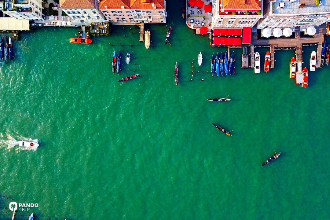 Grand Canal in Venice with gondolas and boats inside the Venetian Lagoon, Italy